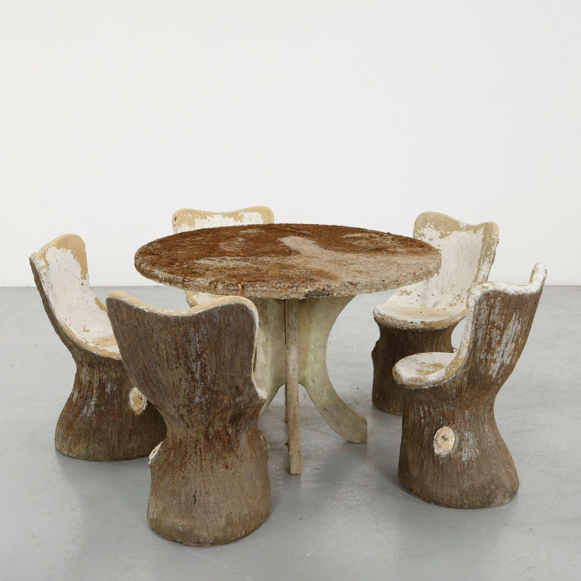 Faux bois concrete dining set with tree-trunk chairs standing on the Mission Road showroom floor