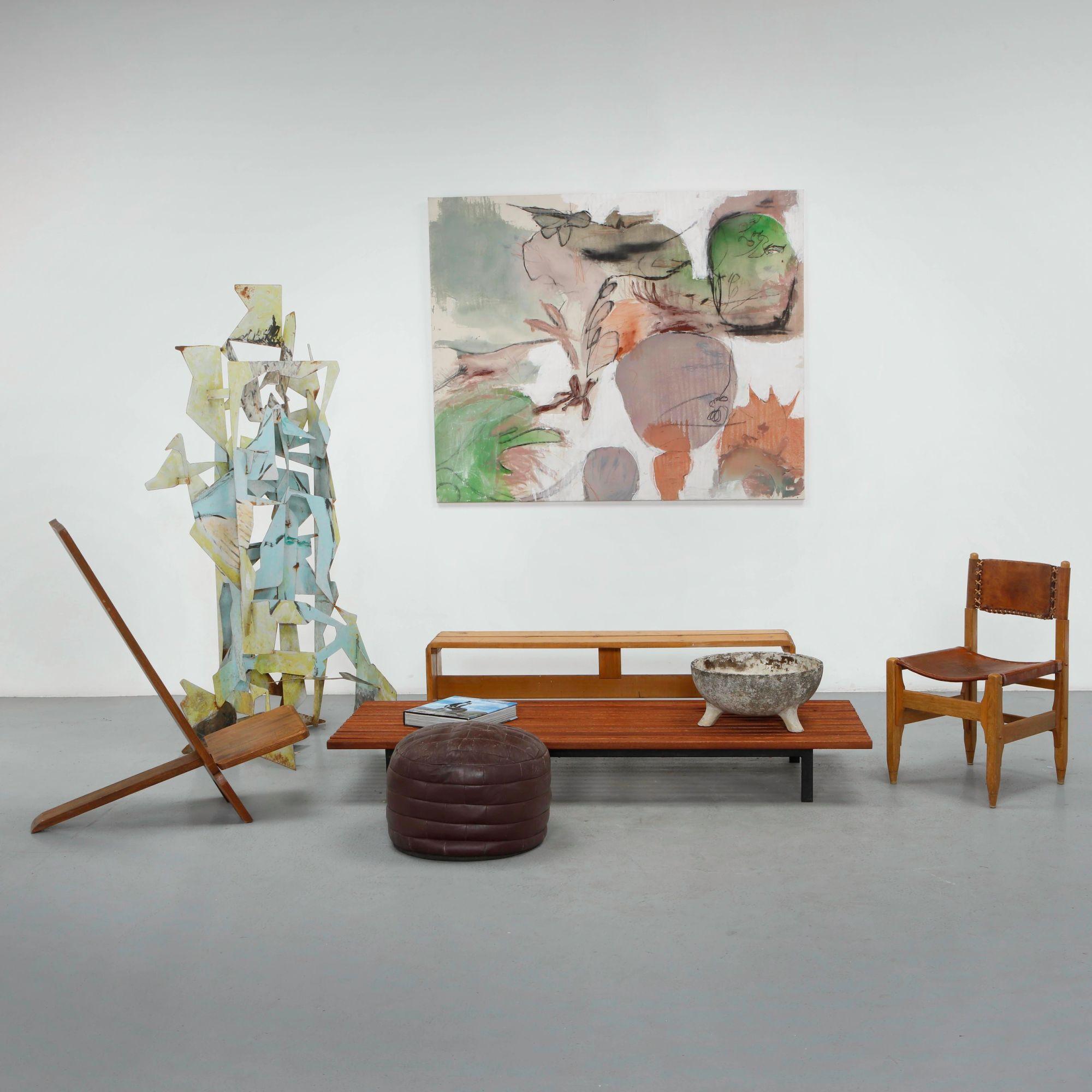 Low modernist bench and stools in front of an abstract painting on the Mission Road showroom floor