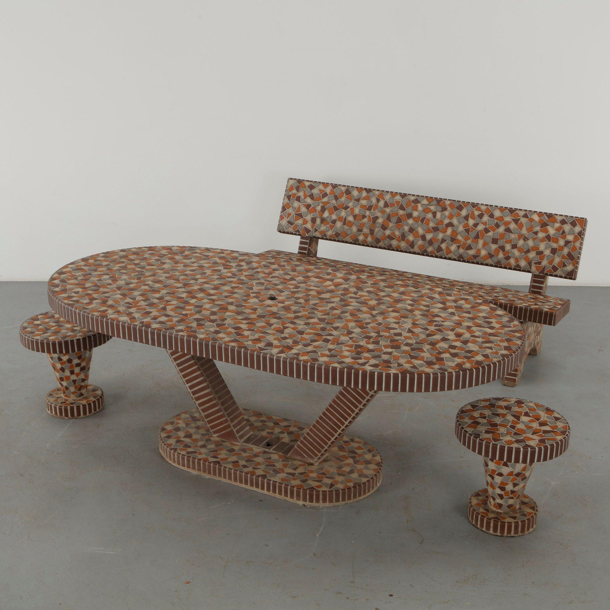 Mosaic clad concrete outdoor dining table with matching bench and two stools in terracotta, cream and brown tesserae